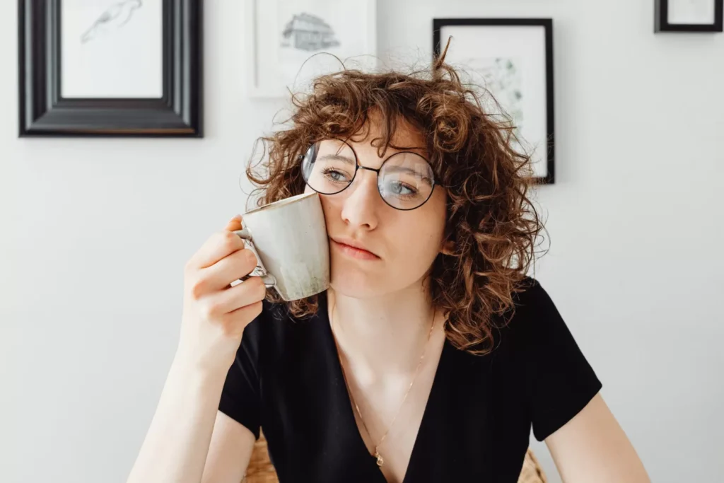 Woman Wondering With Coffee In Hand